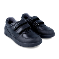 Black leather kids school shoes with double velcro straps and rubber soles on white background.