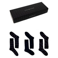 Gift box with three pairs of navy socks in striped, solid, and checked patterns.