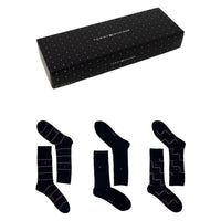 Gift box with three pairs of navy socks in striped, solid, and checked patterns.