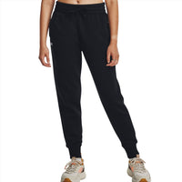 Woman wearing black joggers with drawstring waist and logo, paired with trainers, on white background